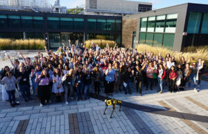 Attendees pose outside Boston Dynamics headquarters for MassRobotics Women in Robotics event.