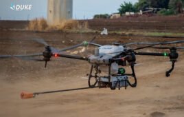 Duke Robotics' Insulator Maintenance Solution, which features a large drone with four propellers, and a hose for spraying.