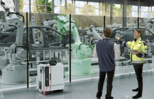 ABB Robotics offers its Energy Efficiency Service, as shown here with a technician and a factory customer.