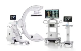 GE HealthCare offers its OEC 3D Imaging System, which is made up of three carts with monitors, and one cart with a large, C shaped device.