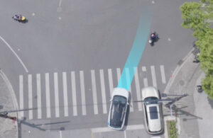 A bird's eye-view of two cars at an intersection. One car has a blue line in front of it, indicated it will pull in front of the other car.