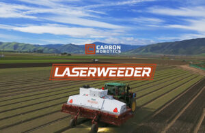 Carbon Robotics' LaserWeeder, which fits onto the front of a tractor, making its way through a large field.