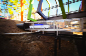 One of Pipedream Labs' underground delivery robots driving through a clear bridge.