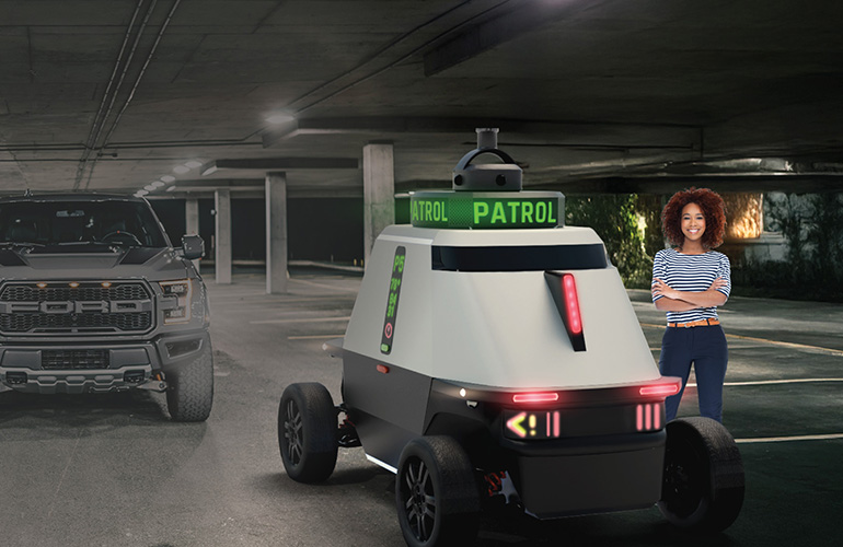 illustration of the RAD ROAMEO Gen4 vehicle next to a woman and a pickup truck for size.