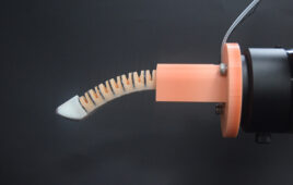 The researchers' robotic finger, which looks like a skinny, ribbed finger with an orange base.