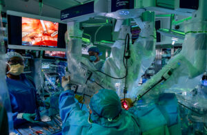 NYU Langone surgeons adjust robotic equipment.