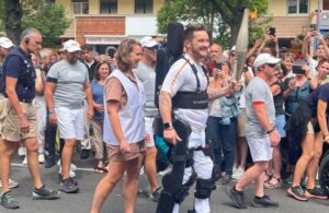 Kevin Piette carries the Olympic torch in Paris. He is a trained Wandercraft test pilot and the device pictured is in the final stages of R&D. Wandercraft will be entering usability and clinical trials soon. The Personal Exoskeleton is not yet available for commercial use.